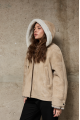 Stylish suede sheepskin coat made of natural sheepskin in beige color with a hood